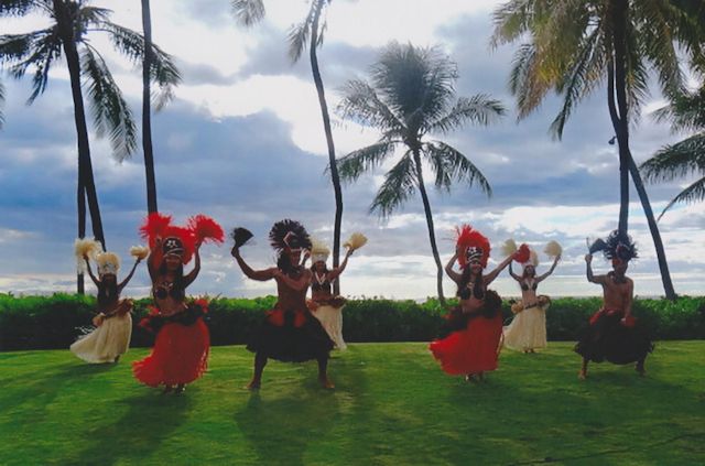 Hawaiian dancers swaying in concert with the palms